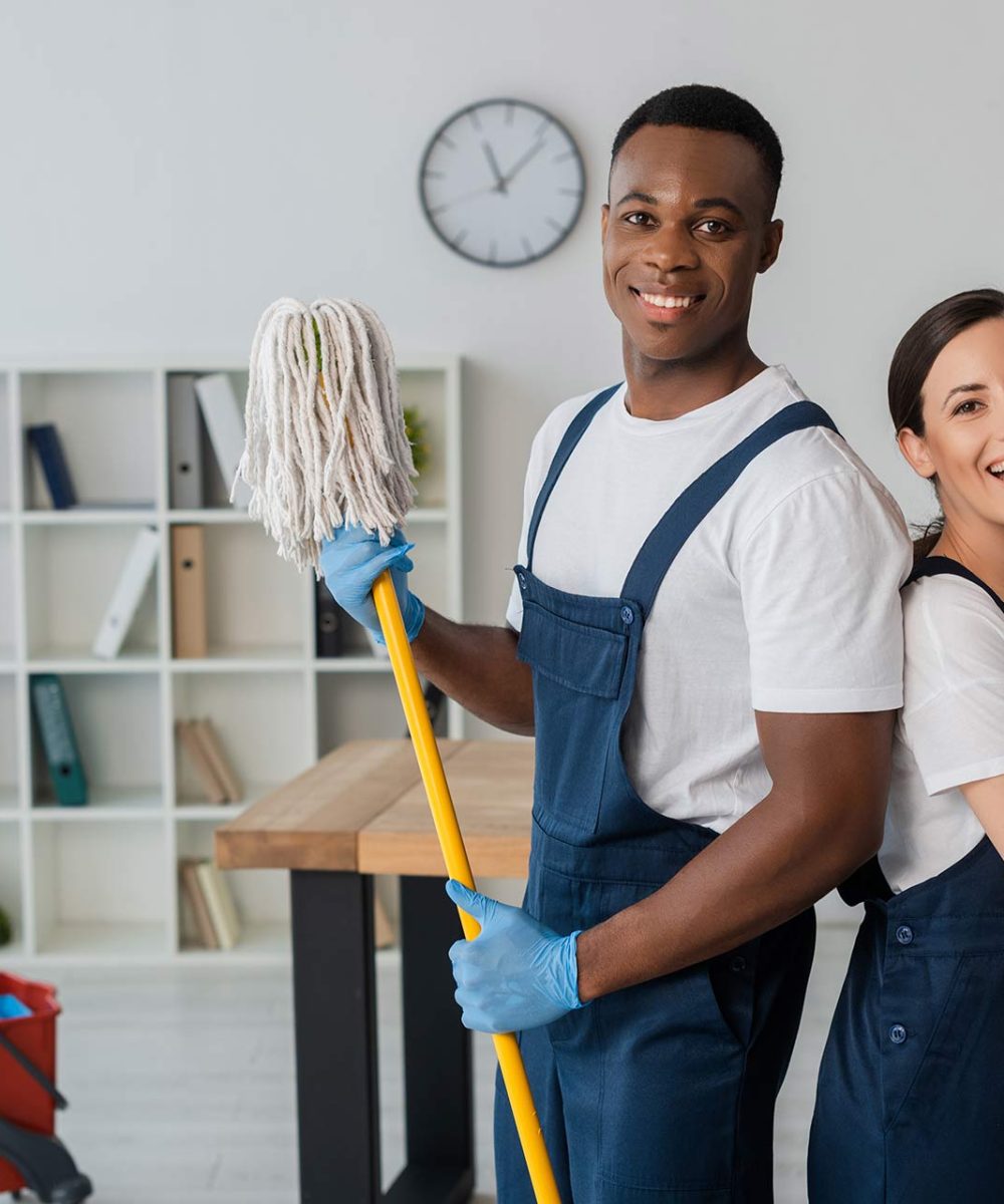 positive-multiethnic-cleaners-holding-mop-and-dete-2024-11-19-09-00-54-A65VTAD-1.jpg